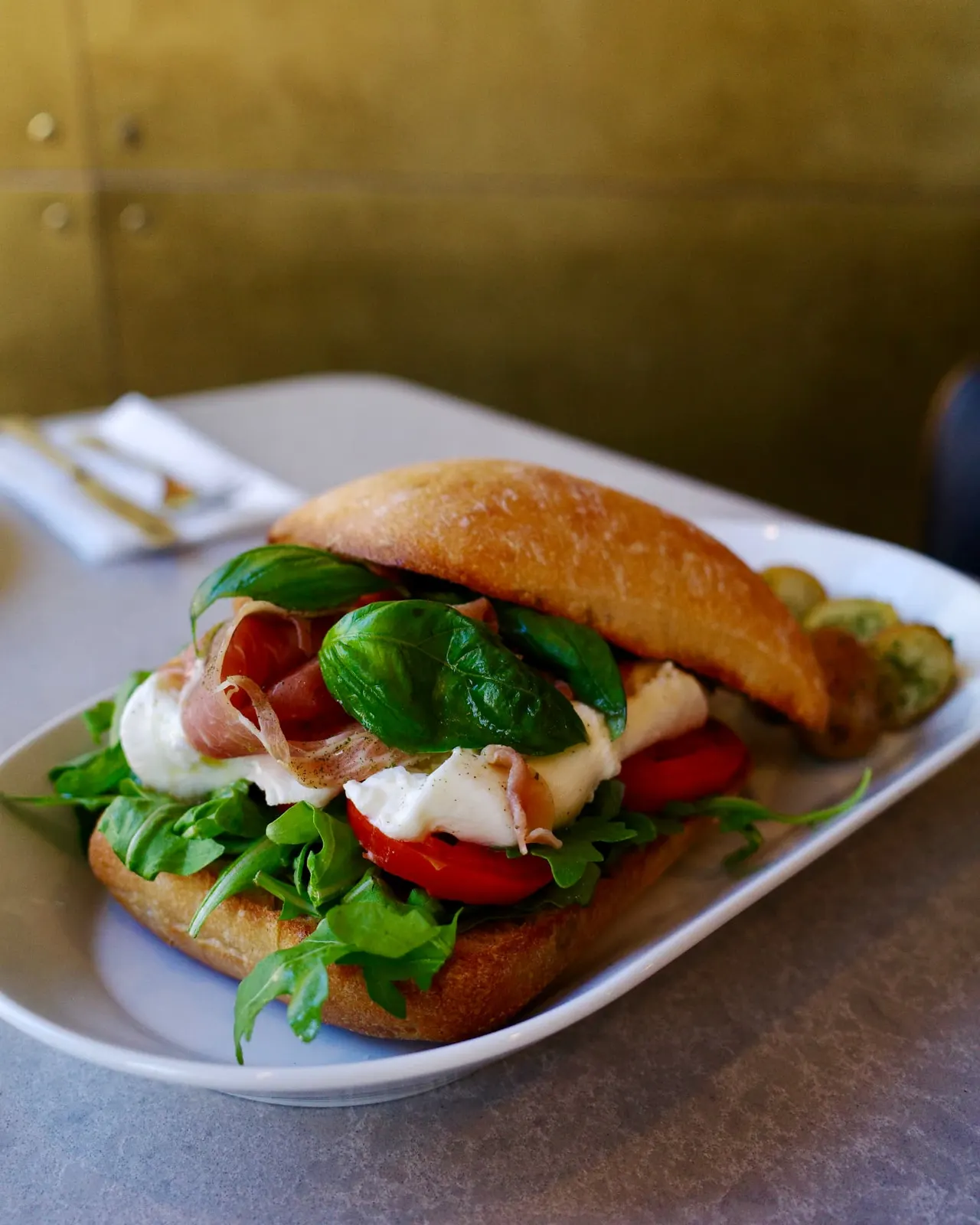 Prosciutto and burrata sandwich on ciabatta with roasted potatoes at Five Corners Ristorante
