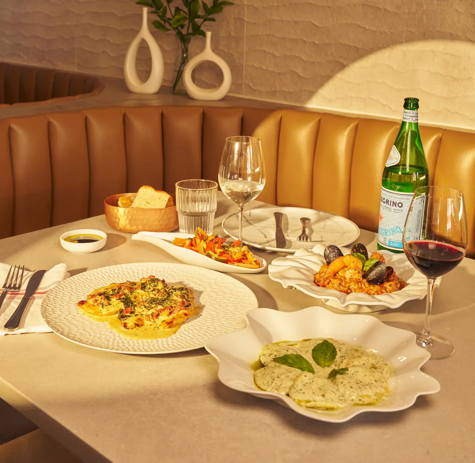 A long table set with Italian dishes and wine at Five Corners Ristorante