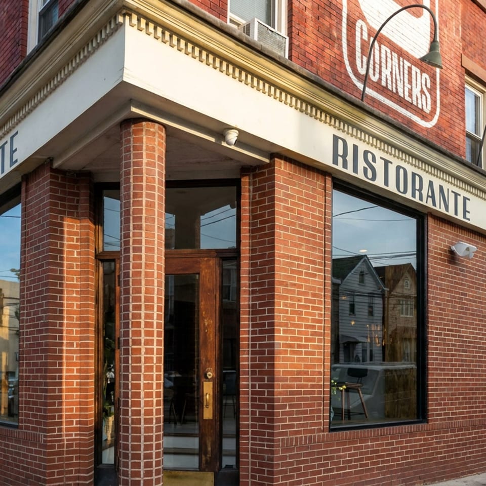 Red-brick corner restaurant building with large windows, arched lamps, and signage reading “CORNERS RISTORANTE.”